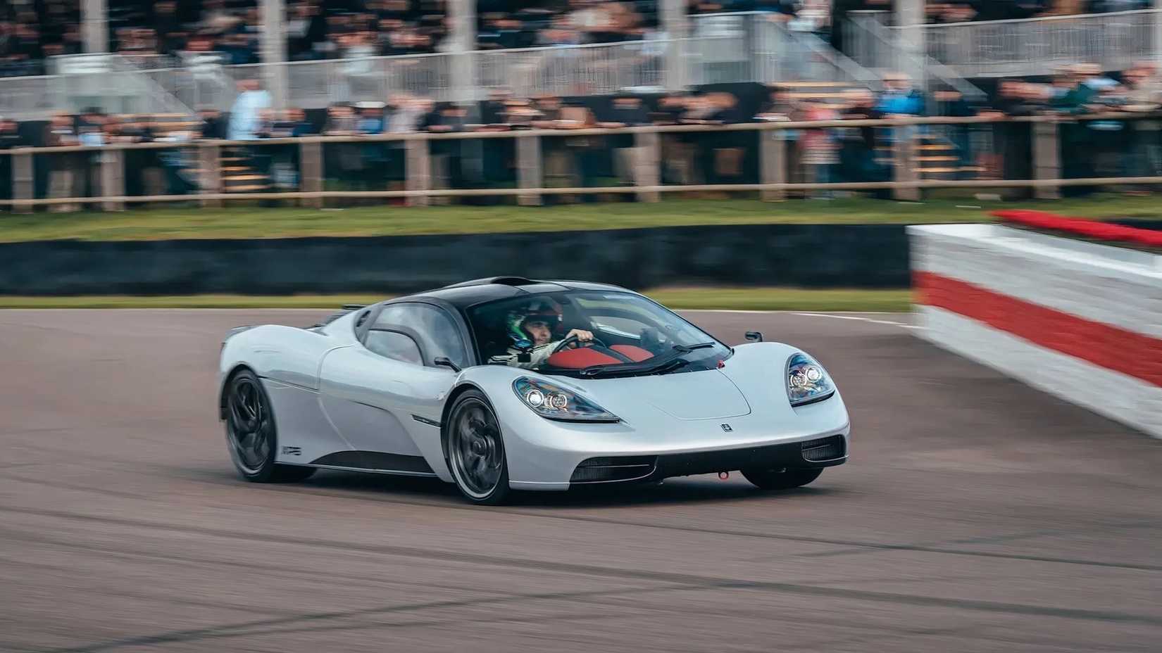 Gordon Murray Automotive T.50 in silver driving at Goodwood racetrack