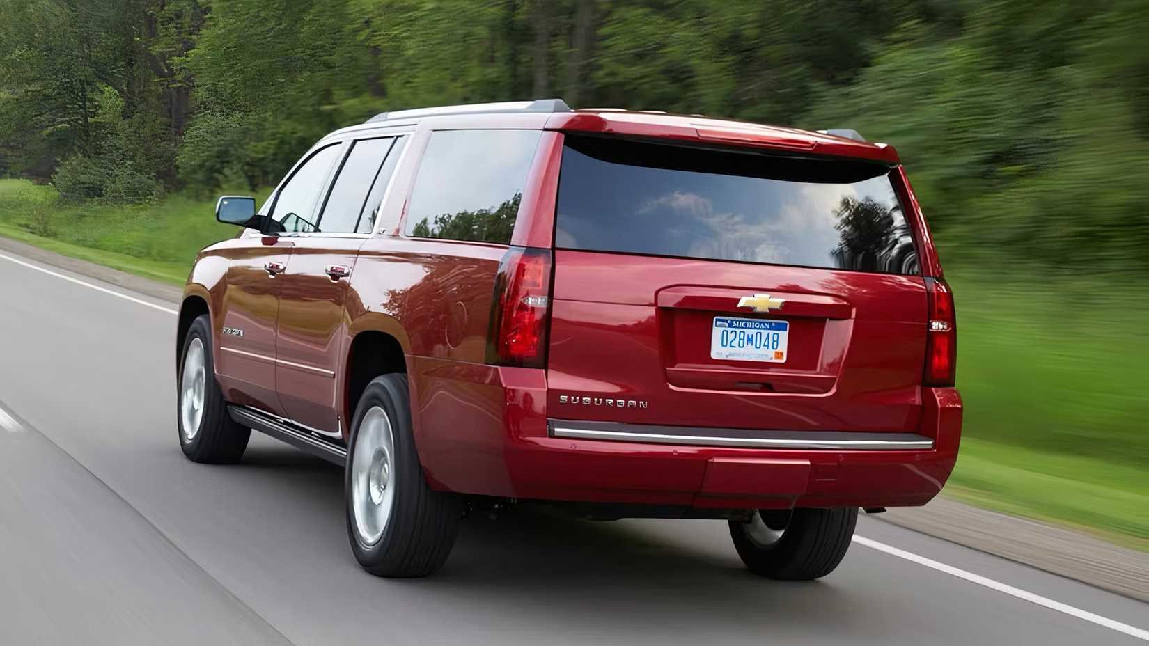 2019 Chevrolet Suburban in red driving on road