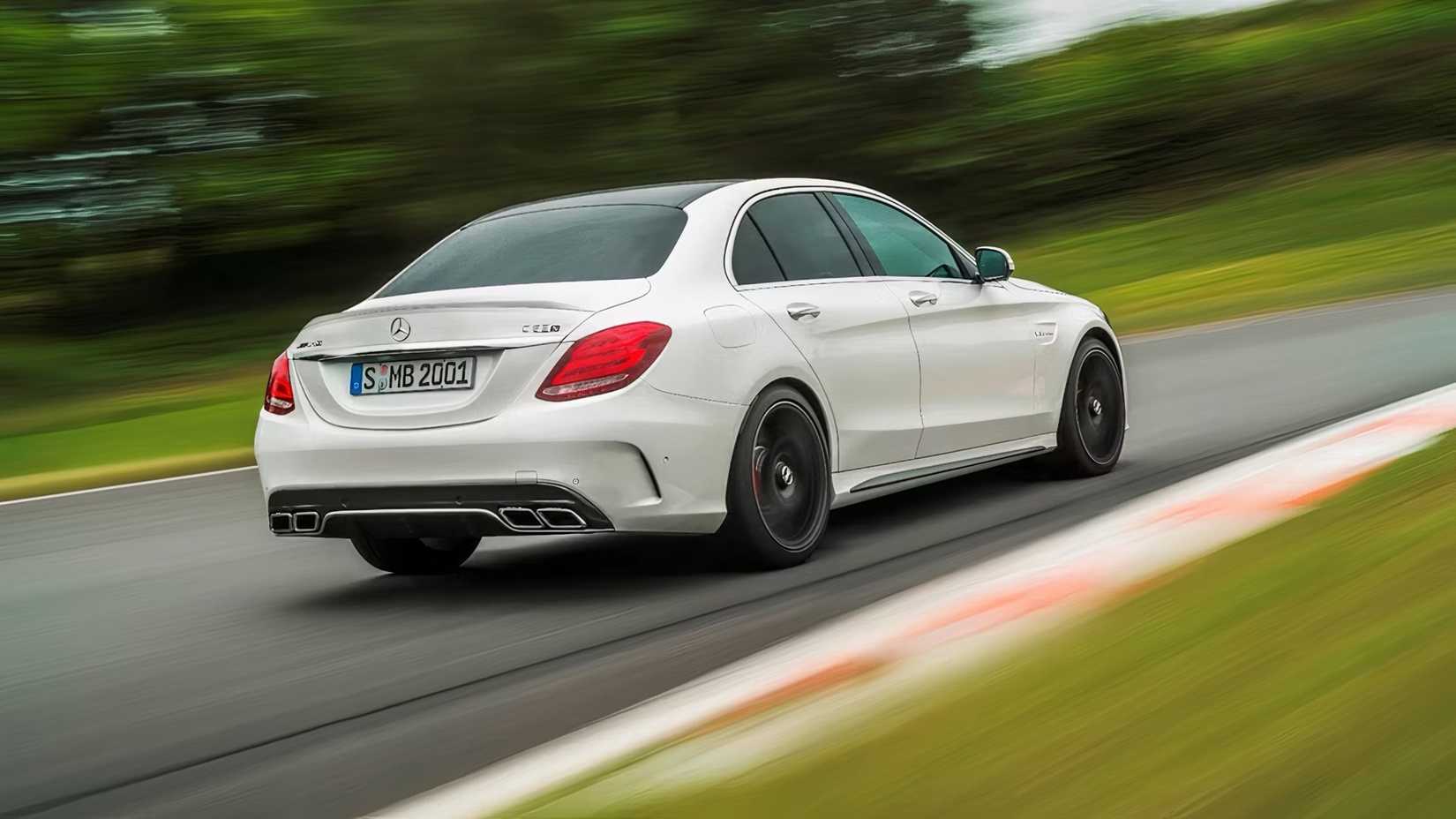 2015 Mercedes-Benz AMG C63 in white driving on road