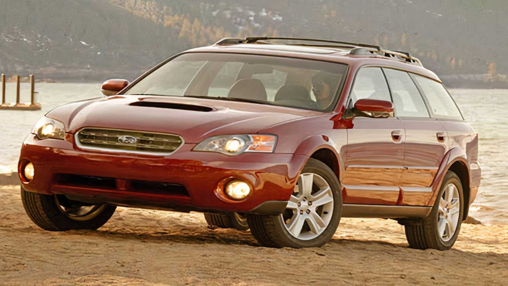 Low-angle front 3/4 shot of 2005 Subaru Outback XT in red driving on beach