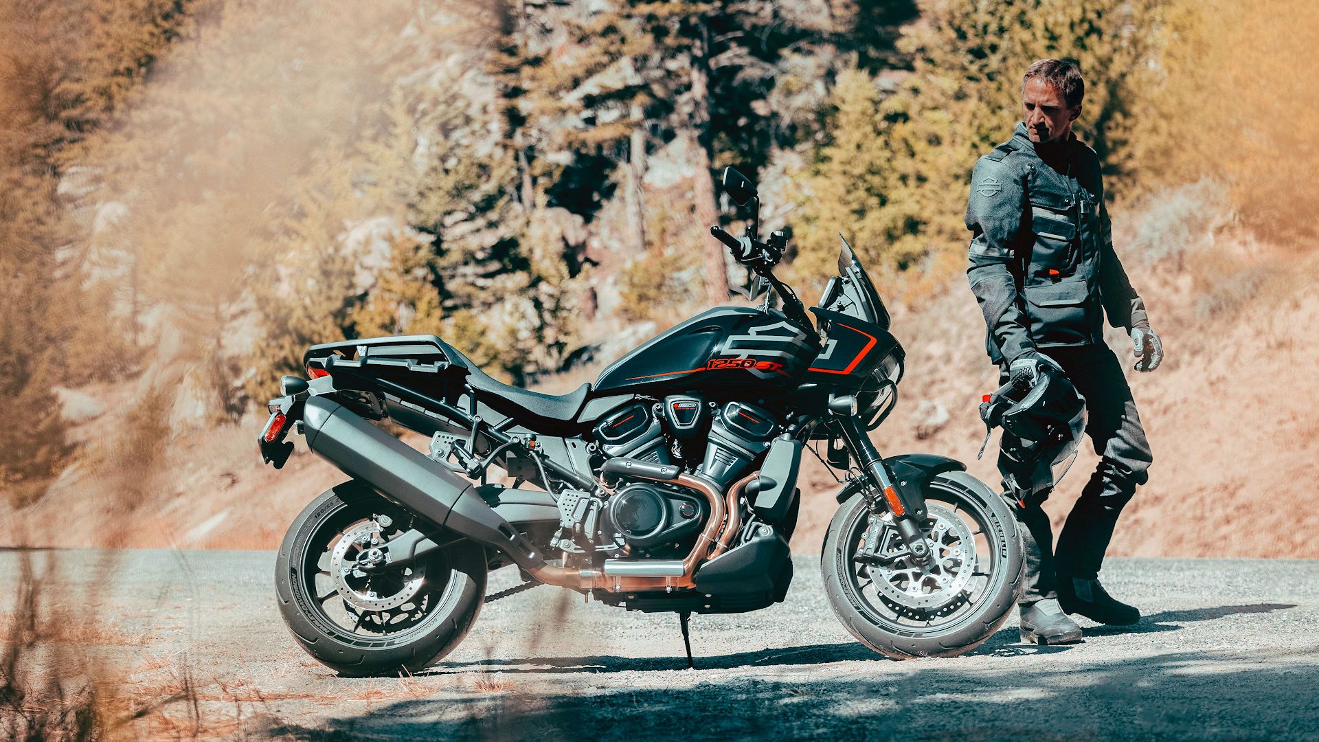 Rider standing next to a 2025 Harley-Davidson Pan America 1250 ST
