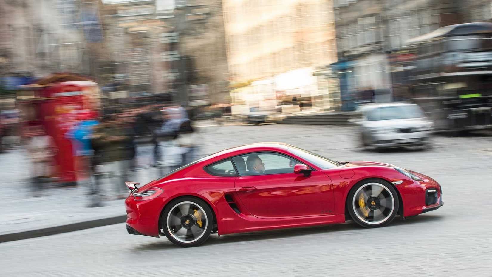 Porsche Cayman GTS (2015), side shot driving through city