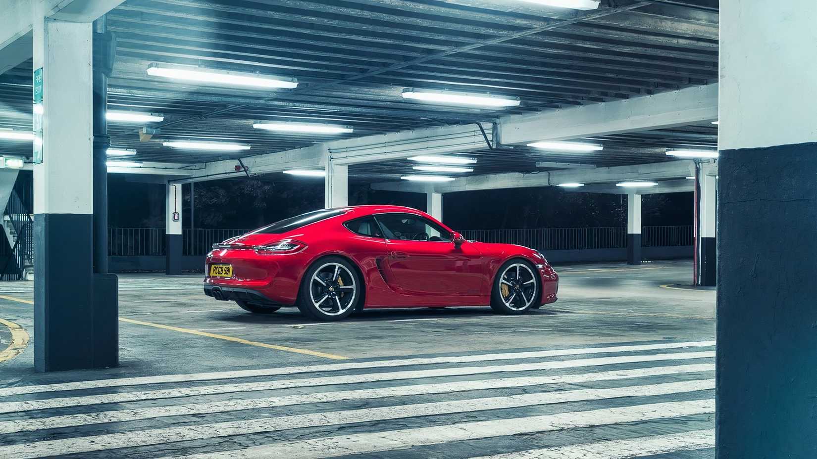 Porsche Cayman GTS (2015), rear 3/4 shot parked in garage
