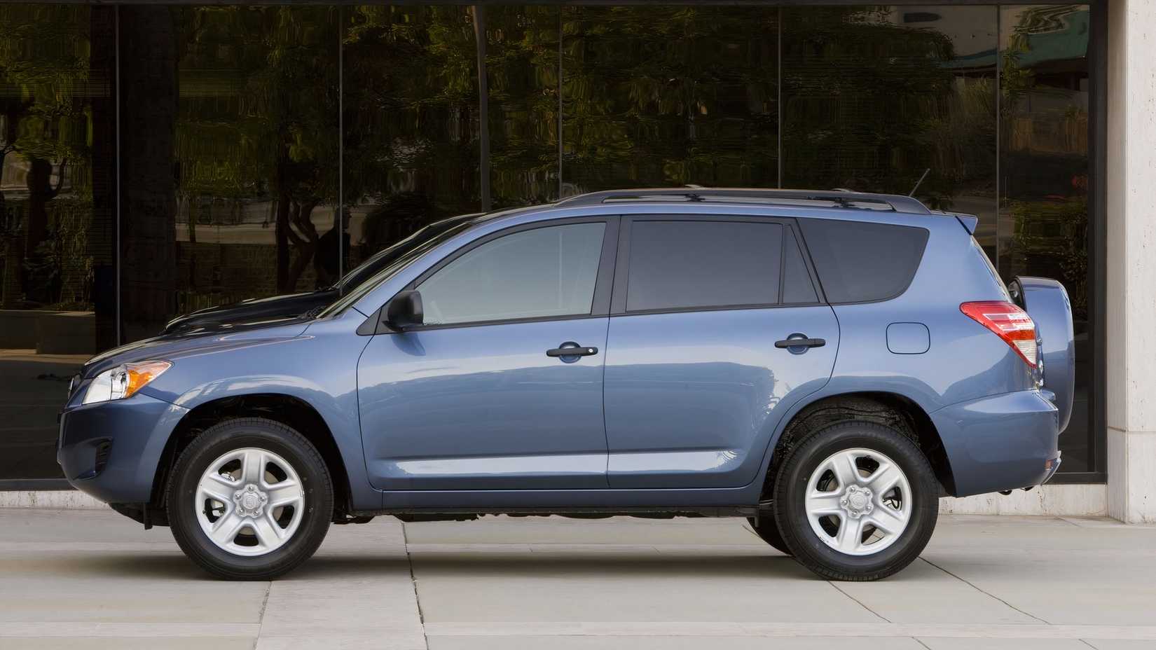 2012 Toyota RAV4 side shot parked in front of a building
