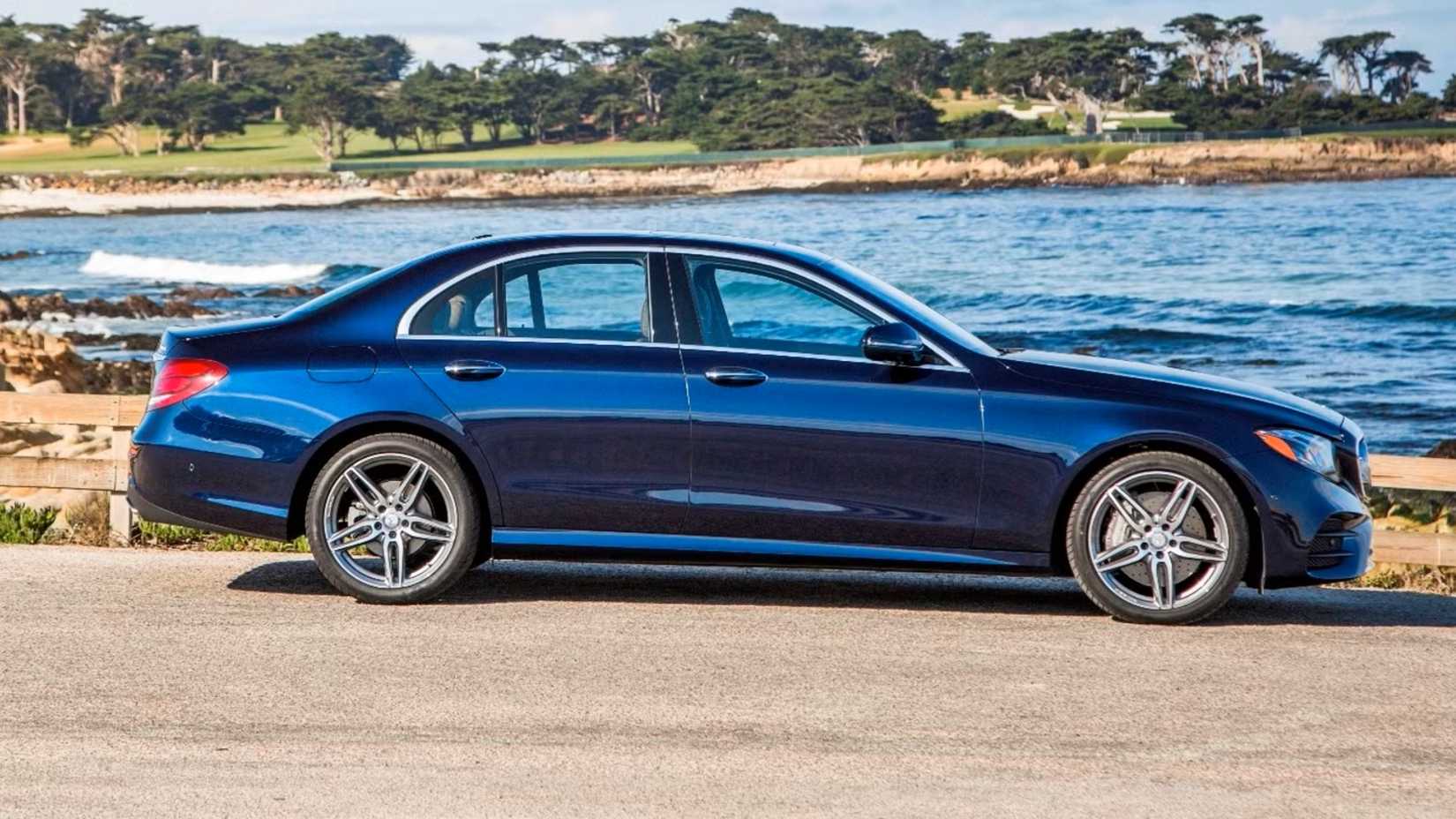 Blue 2020 Mercedes E-Class Sedan side shot parked in front of water