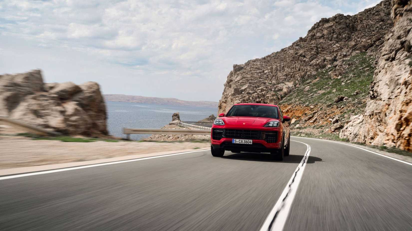 2025 Porsche Cayenne in red being driven on road