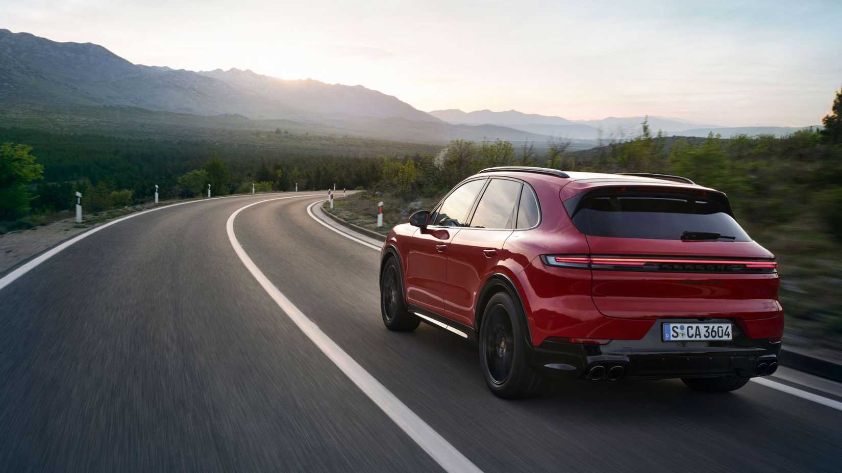 2025 Porsche Cayenne in red being driven on road