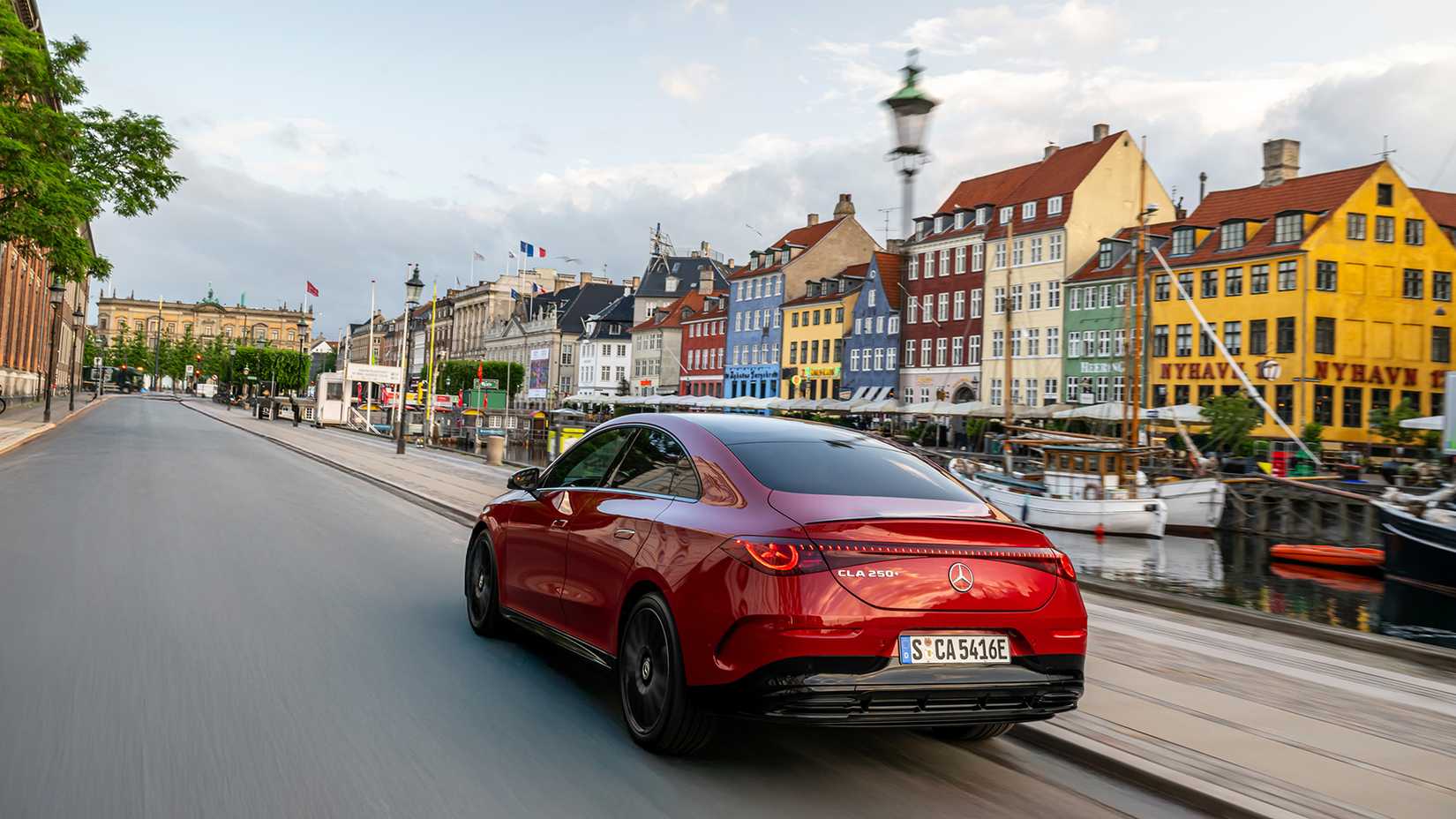2026 Mercedes-Benz CLA rear 3/4 shot driving through city