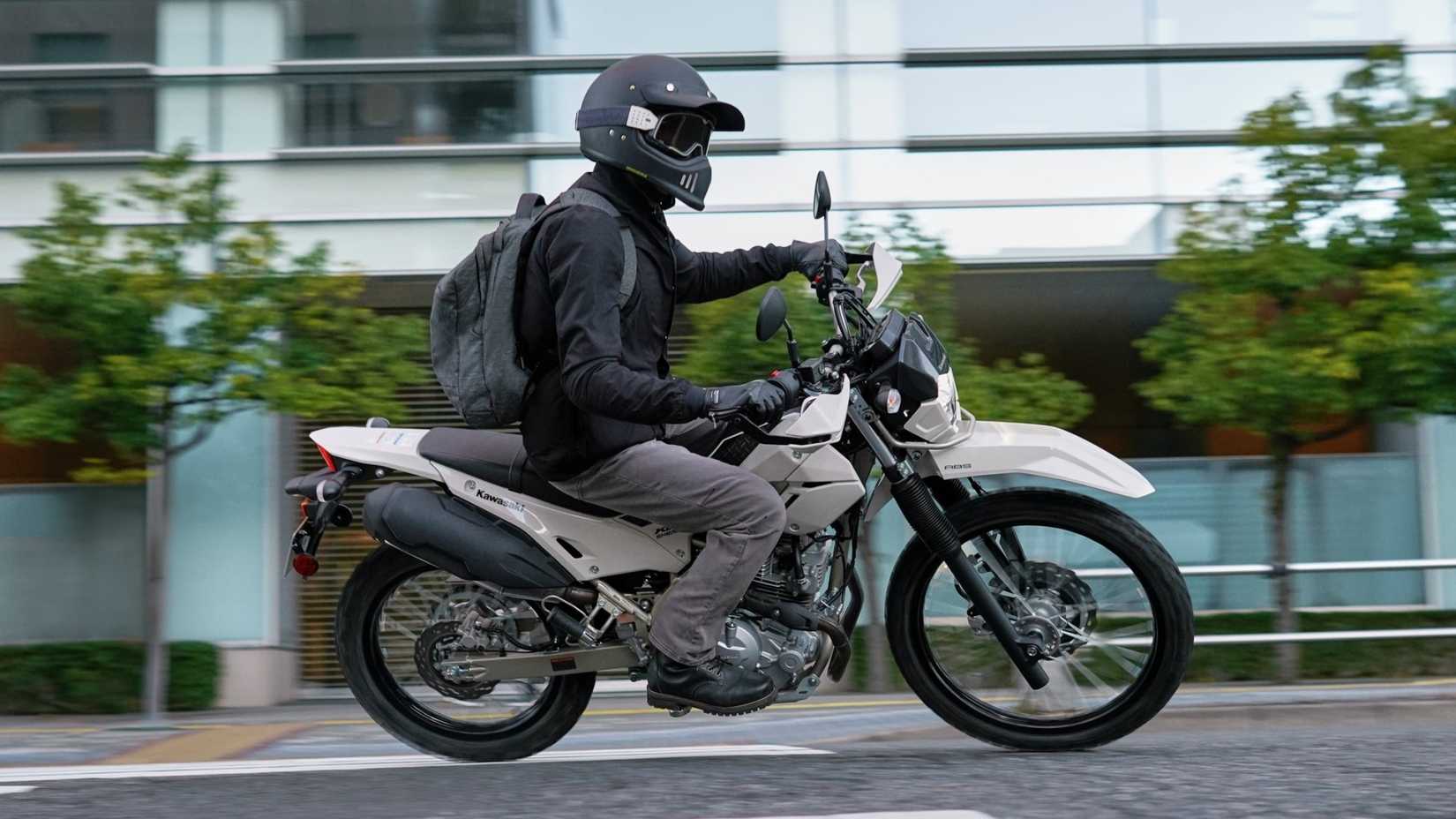 2026 Kawasaki KLX230 Sherpa S cornering through city traffic