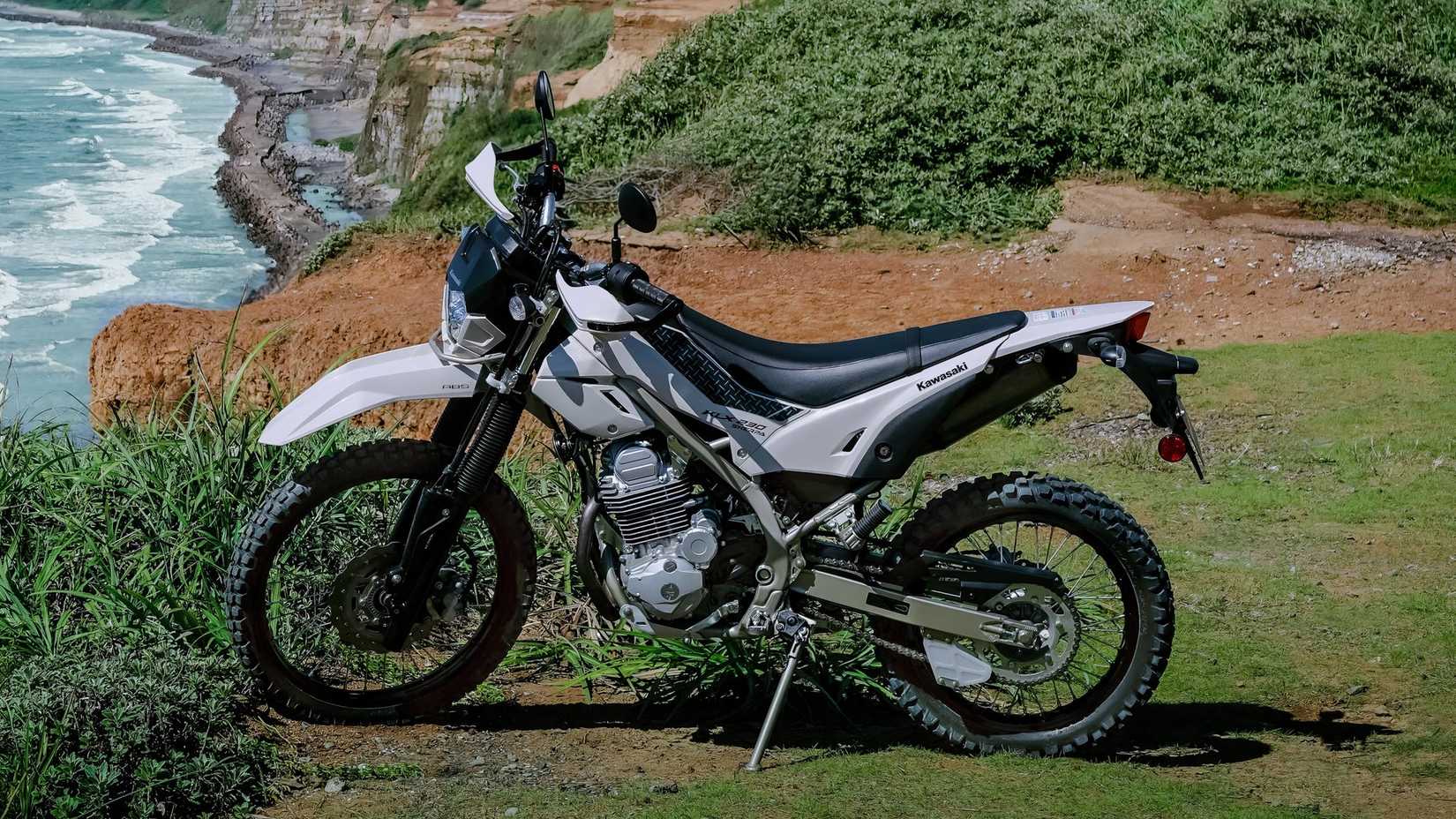 2026 Kawasaki KLX230 Sherpa S from the side, overlooking a cliff