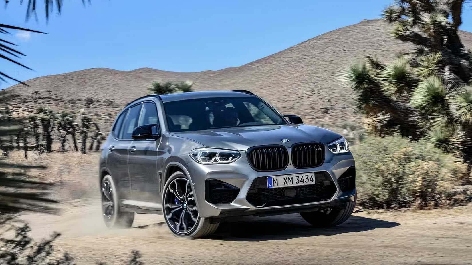 2020 BMW X3 M in silver being driven off-road