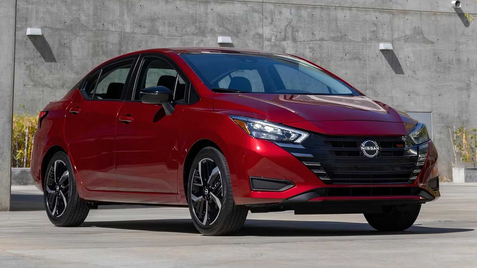 2025 Nissan Versa in red parked 