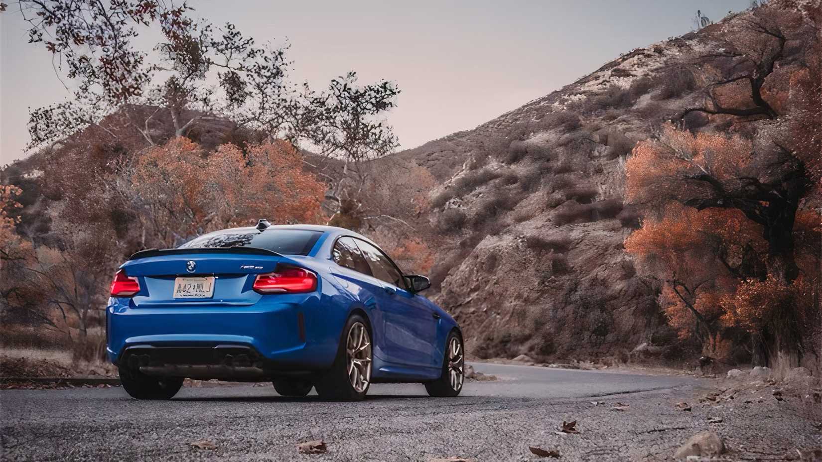 Rear 3/4 shot of 2020 BMW M2 CS in blue parked on road