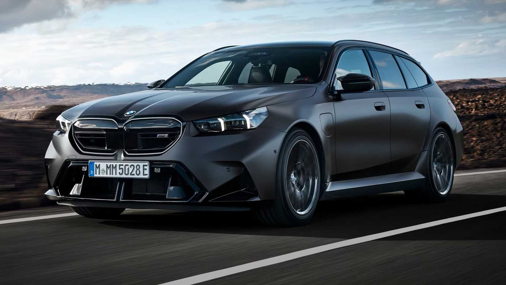 2025 BMW M5 Touring in matte black driving on road