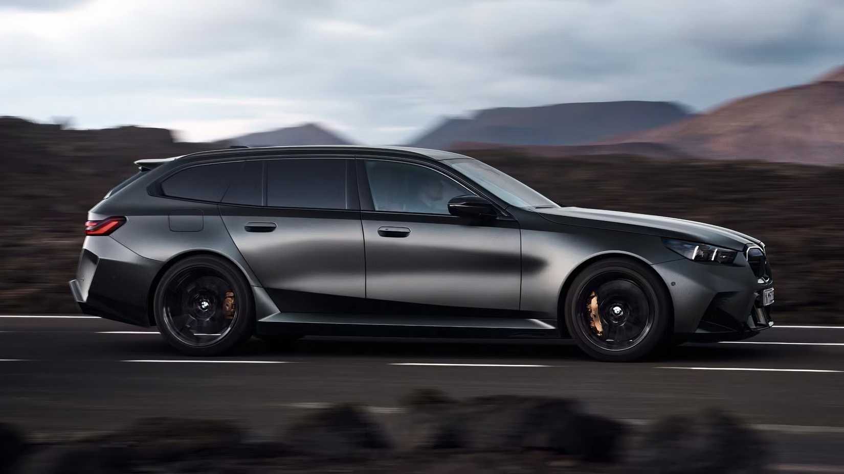 2025 BMW M5 Touring in matte black driving on road