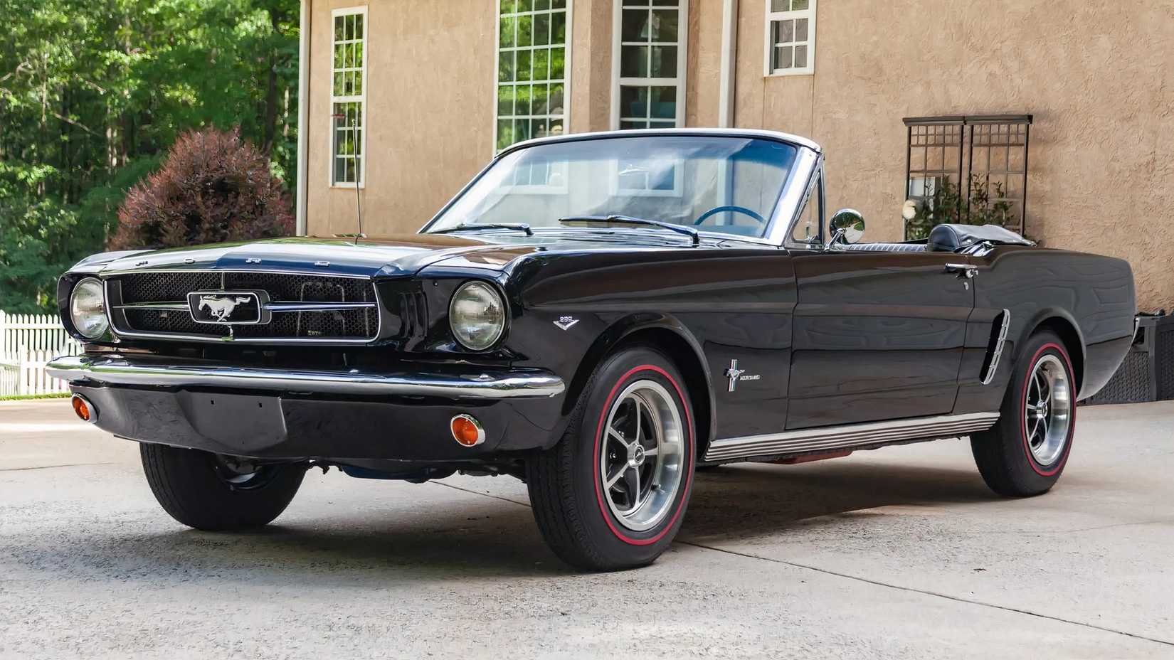 1964 Ford Mustang in black parked on driveway