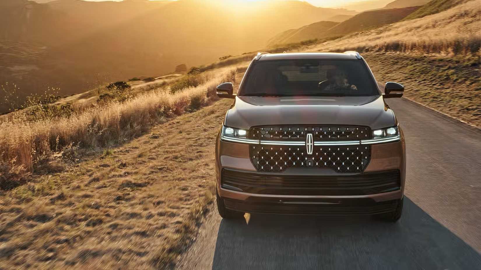 2025 Lincoln Navigator in gold driving on mountain road