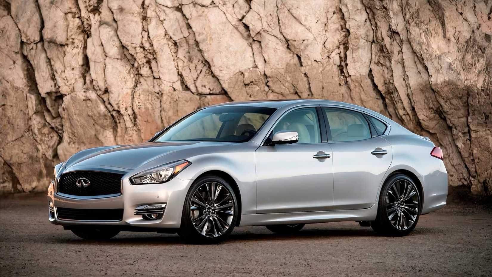 Foto frontal 3/4 do Infiniti Q70 2018 em prata estacionado off-road