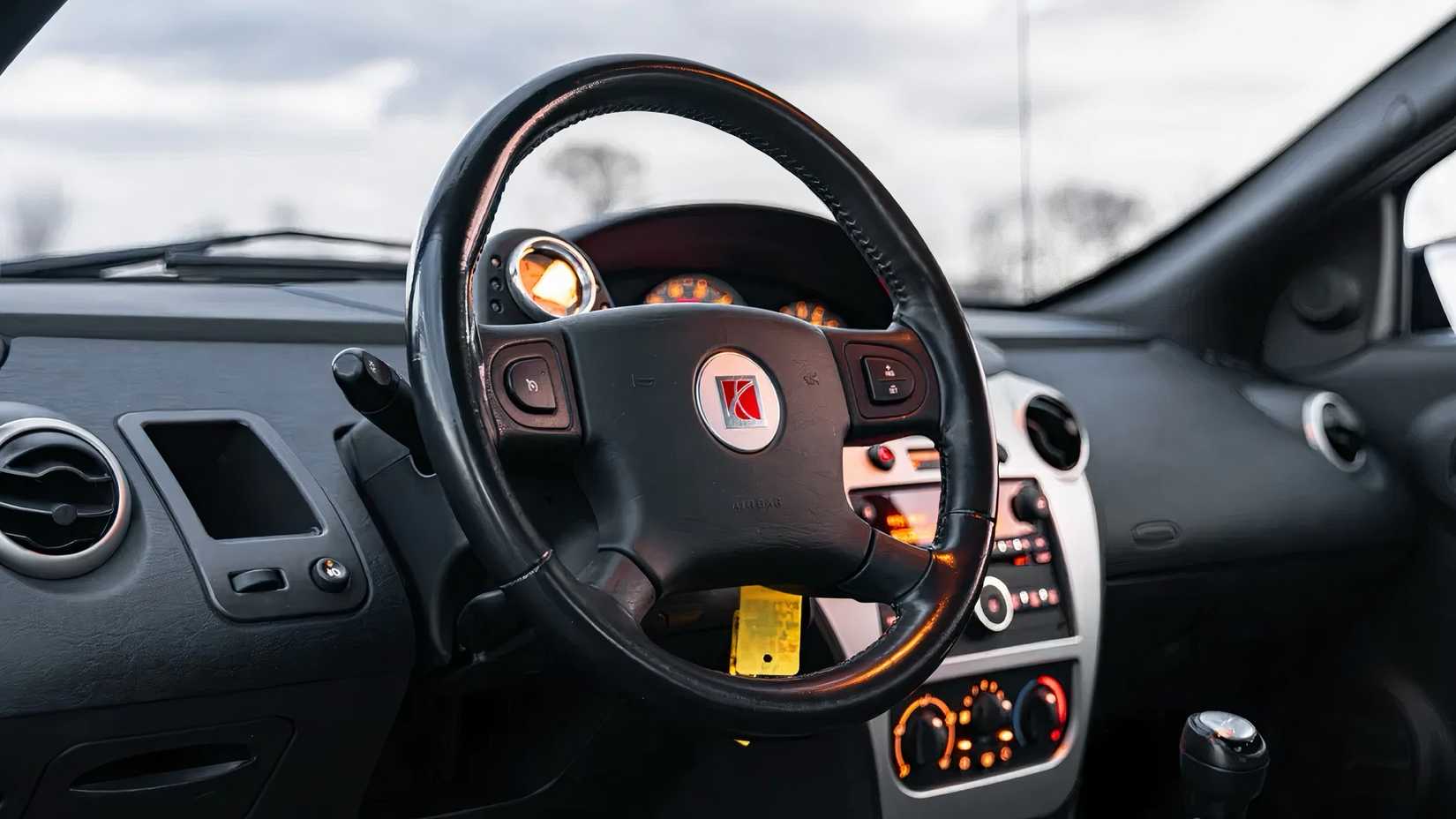 2007 Saturn Ion Quad Coupe Redline Edition interior showing steering wheel and dash
