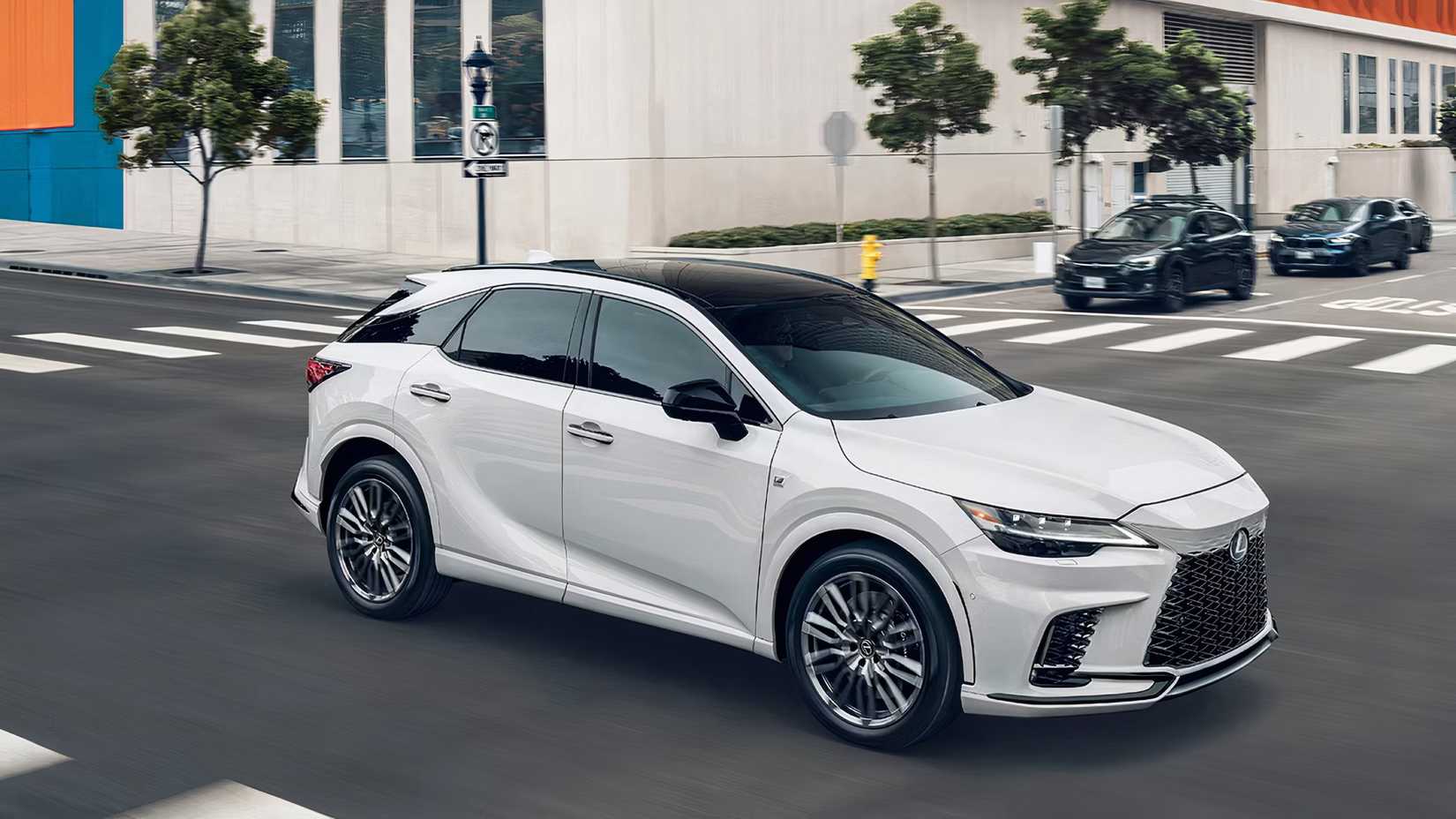2025 Lexus RX 500h F Sport Performance AWD in white driving on city street