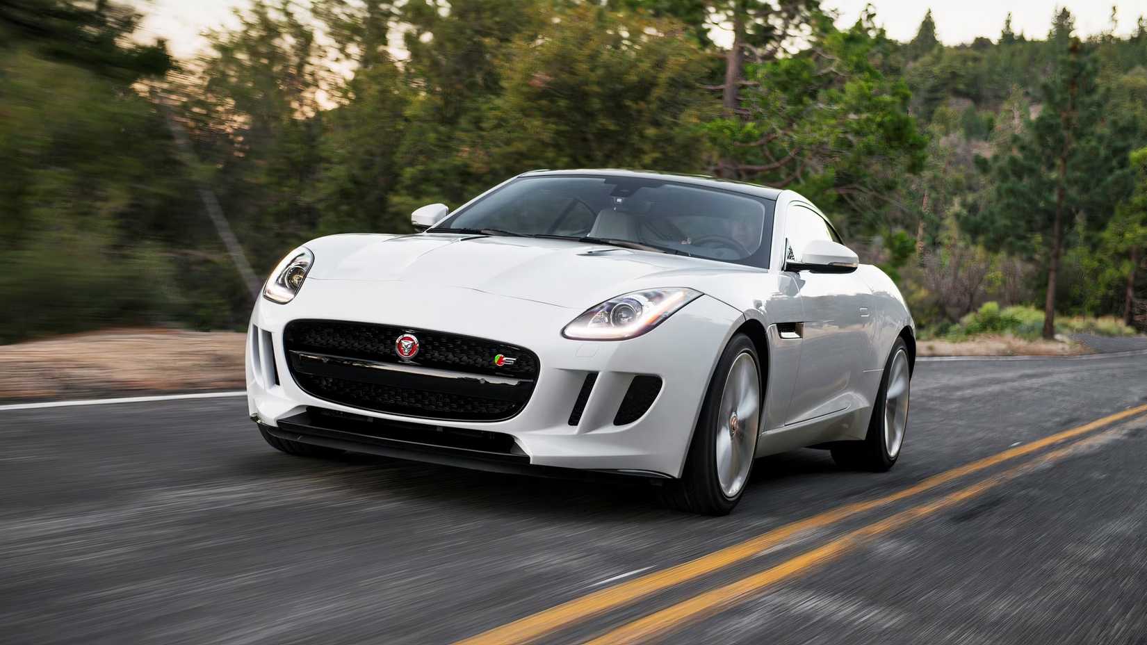 Uma vista frontal de um Jaguar F-Type 2017 dirigindo em uma estrada vazia