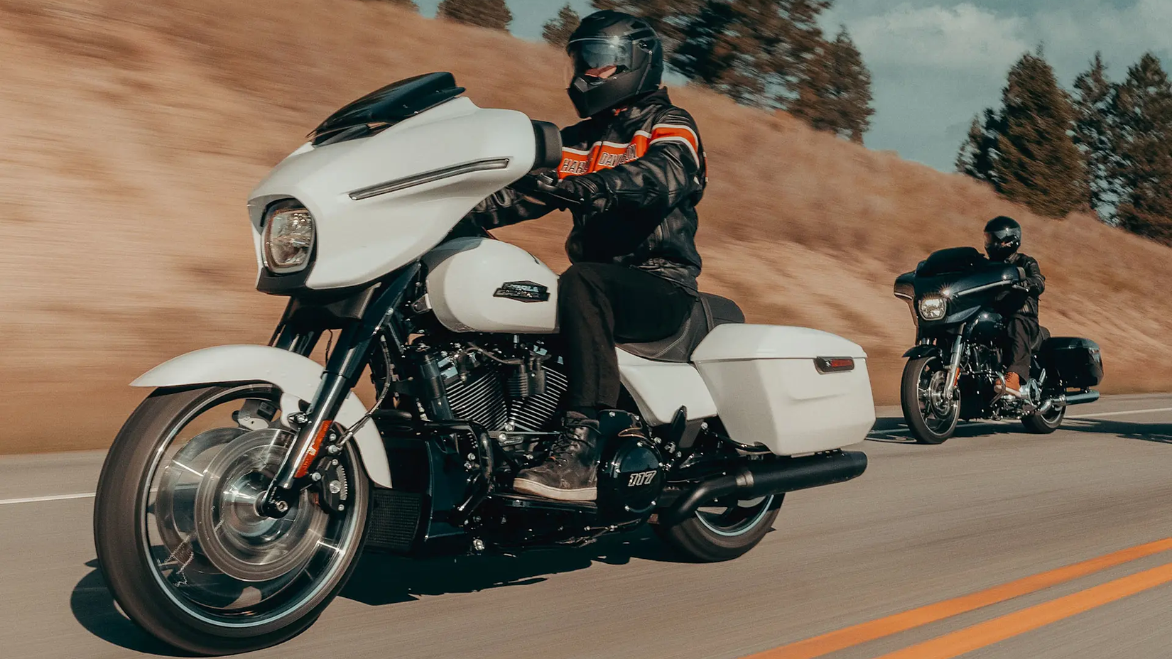 Riders on 2025 Harley-Davidson Street Glide models cruising on a country road