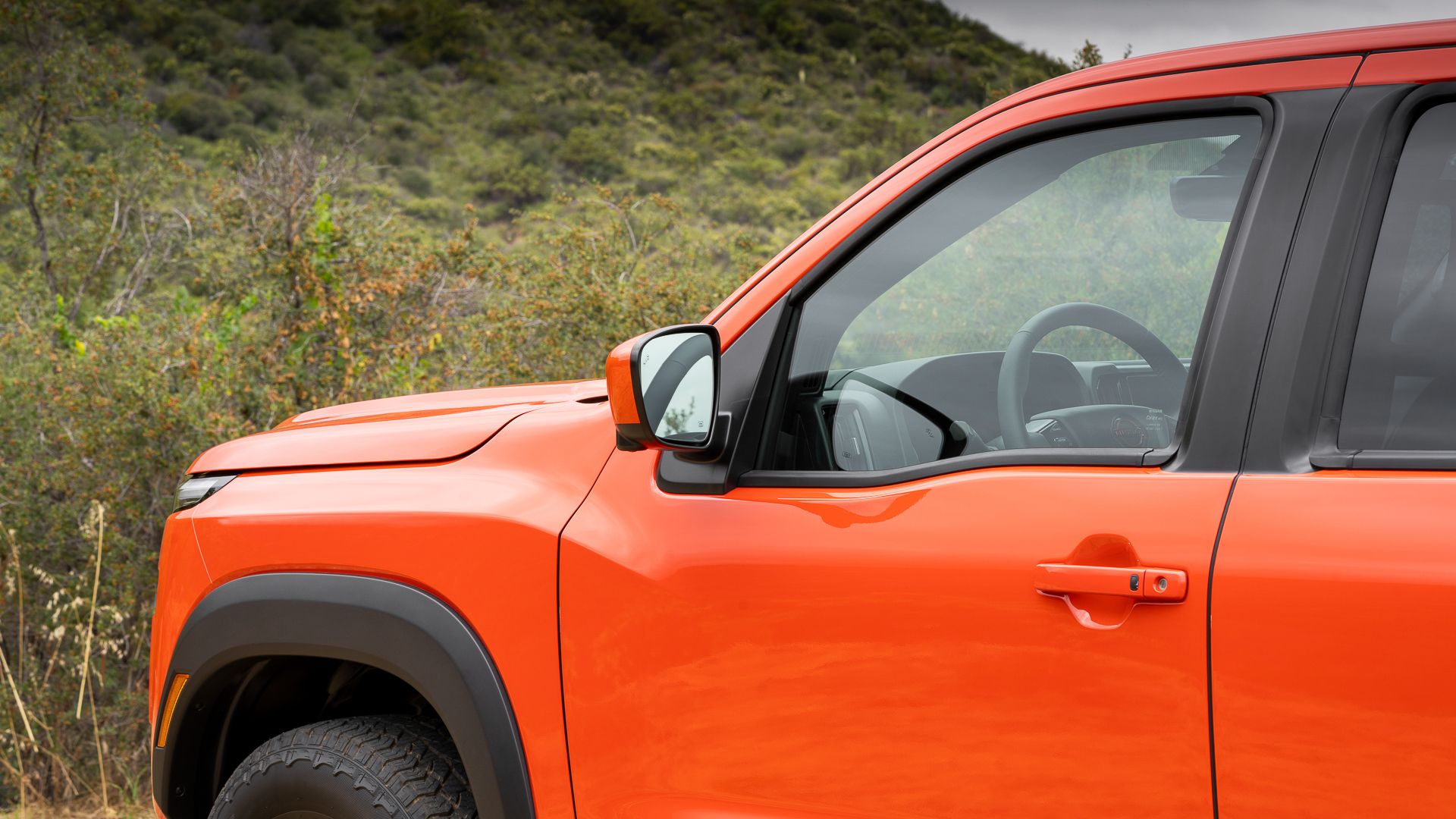 Side close-up of a 2026 Nissan Frontier Pro-4X front quarter