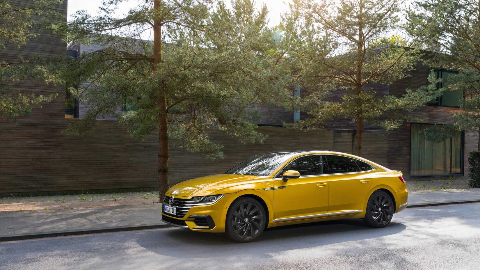 Yellow Volkswagen Arteon parked on suburban street
