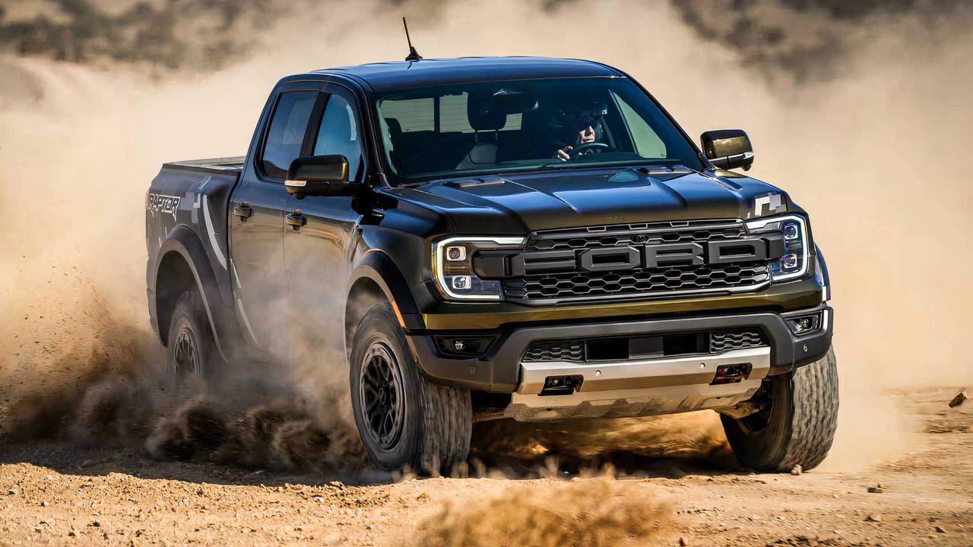 2025 Ford Ranger Raptor in black driving through desert