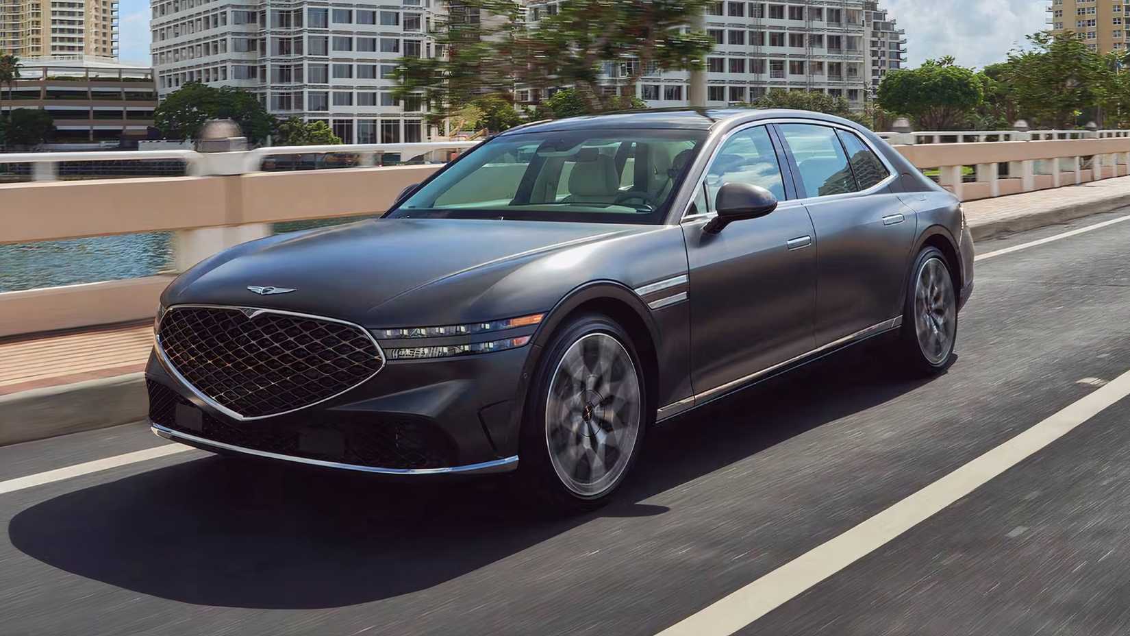 Side 3/4 action shot of 2025 Genesis G90 3.5T in gray driving on road