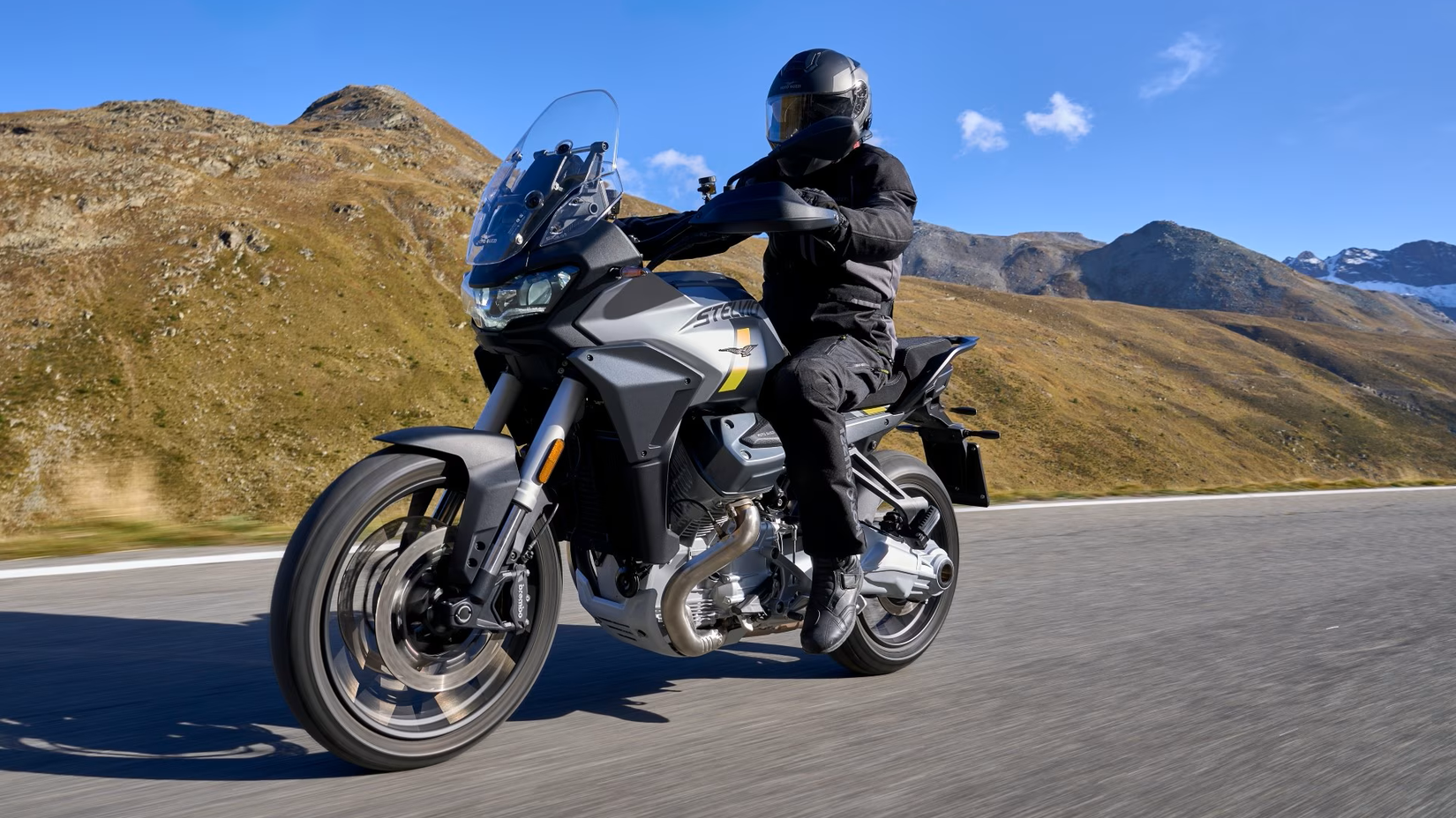 Moto Guzzi Stelvio accelerating on a road, front third quarter view