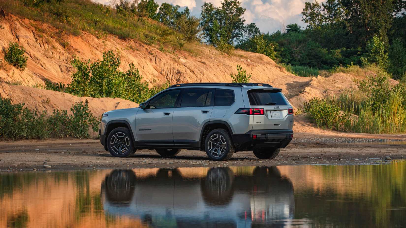 2026 Jeep Cherokee Hybrid in gray parked by lake
