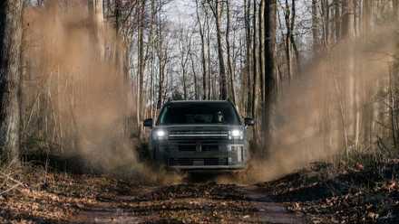 Front shot of a 2026 Hyundai Santa Fe driving through off-road trail
