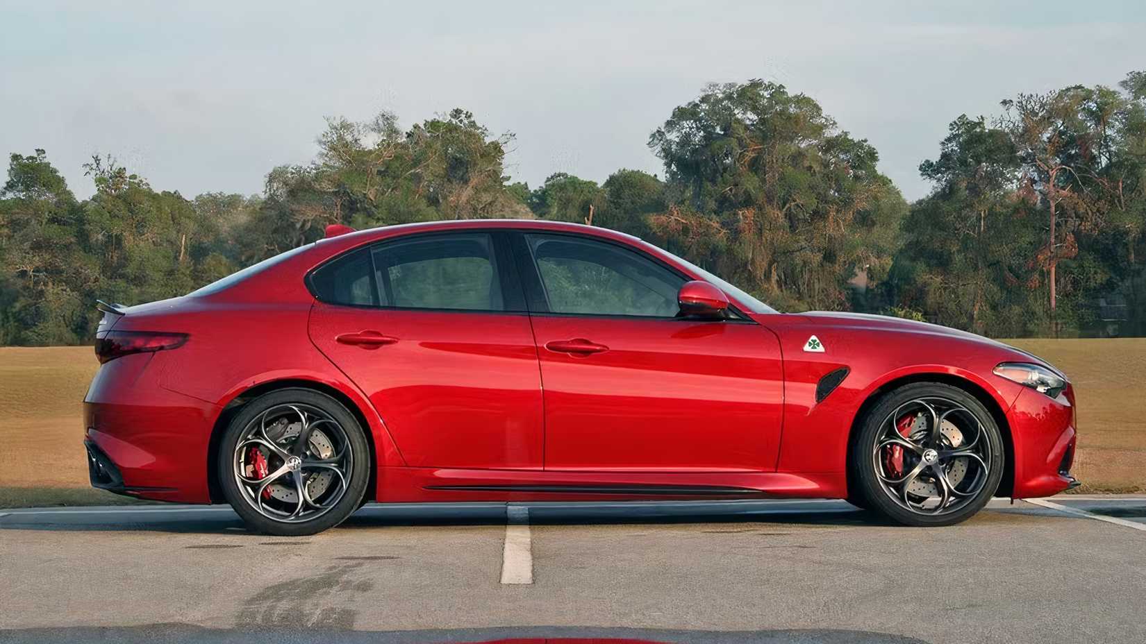 Side shot of a red 2017 Alfa Romeo Giulia Quadrifoglio in parking lot