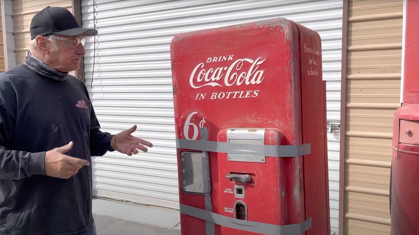 Rick Dale from American Restoration standing in front of Model 51 Cavalier Coca-Cola Machine