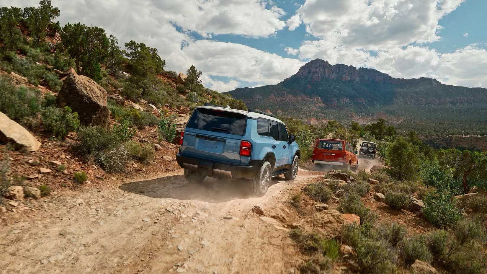 2025 Toyota Land Cruiser in blue being driven down off-road track