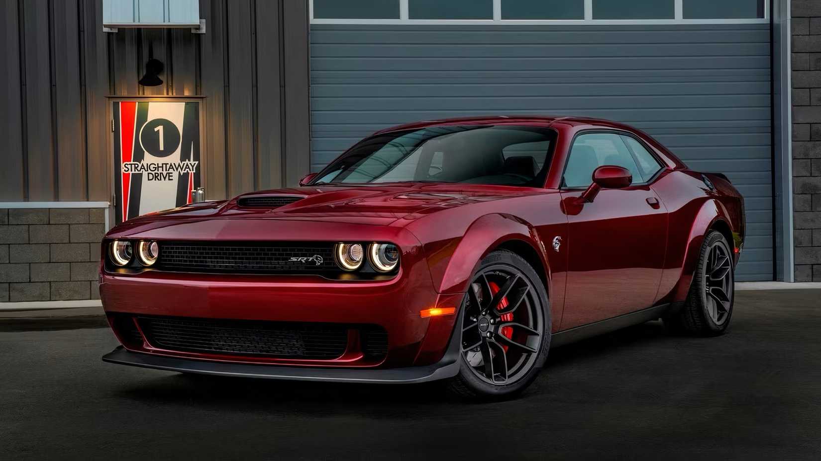 2015 Dodge Challenger SRT Hellcat in red parked outside of garage