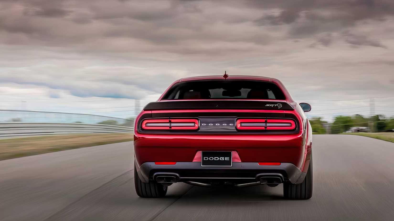 2015 Dodge Challenger SRT Hellcat in red being driven on road
