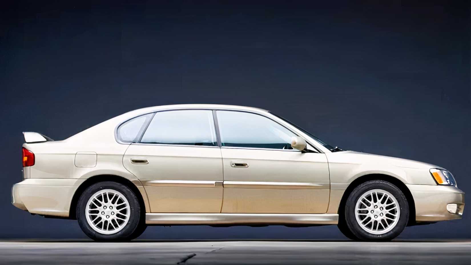 1990 Subaru Legacy L in gold parked