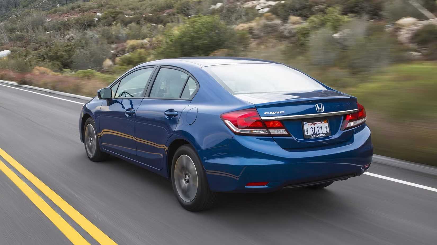 2015 Honda Civic in blue being driven on road