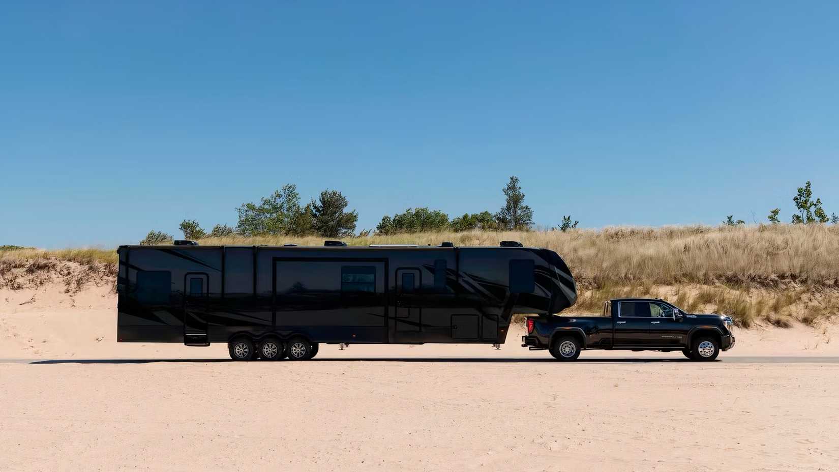 2025 GMC Sierra 3500HD in black with trailer attached