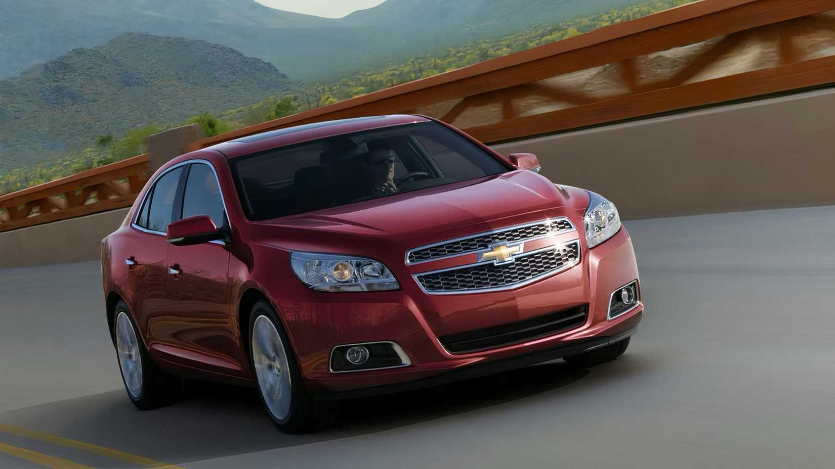 2015 Chevrolet Malibu in red being driven on road
