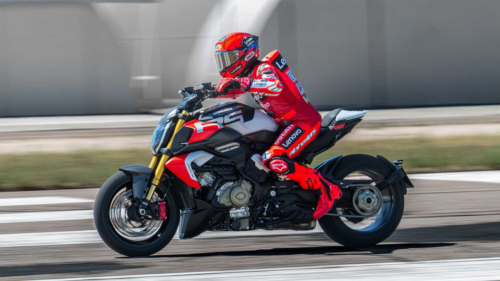 2026 Ducati Diavel V4 RS acelerando agressivamente a vista de perfil lateral