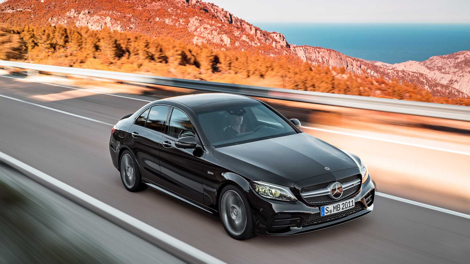 Foto frontal de um Mercedes-AMG C43 preto 2019 dirigindo pela estrada
