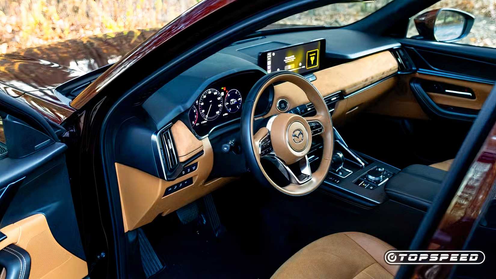 Foto do interior do Mazda CX-90 2025 mostrando a cabine frontal