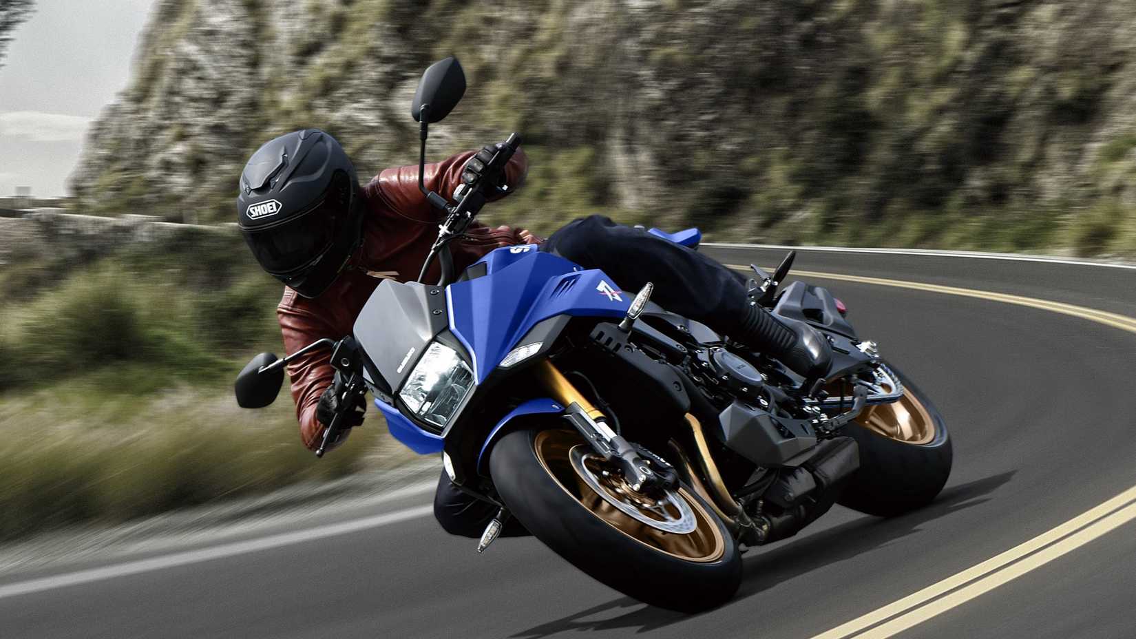 2024 Suzuki Katana speeding down a mountain road
