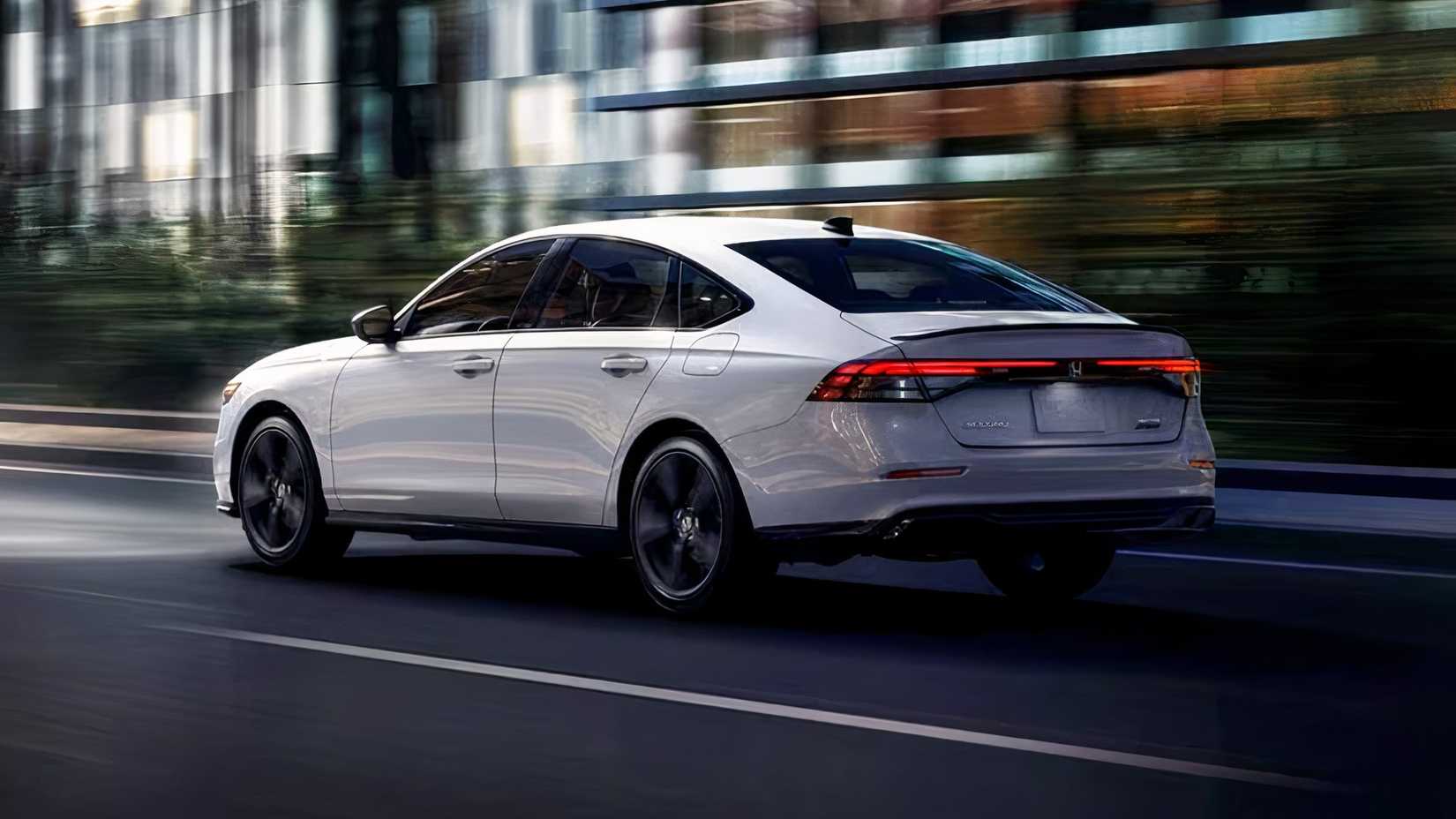 2025 Honda Accord Touring Hybrid in white being driven on road