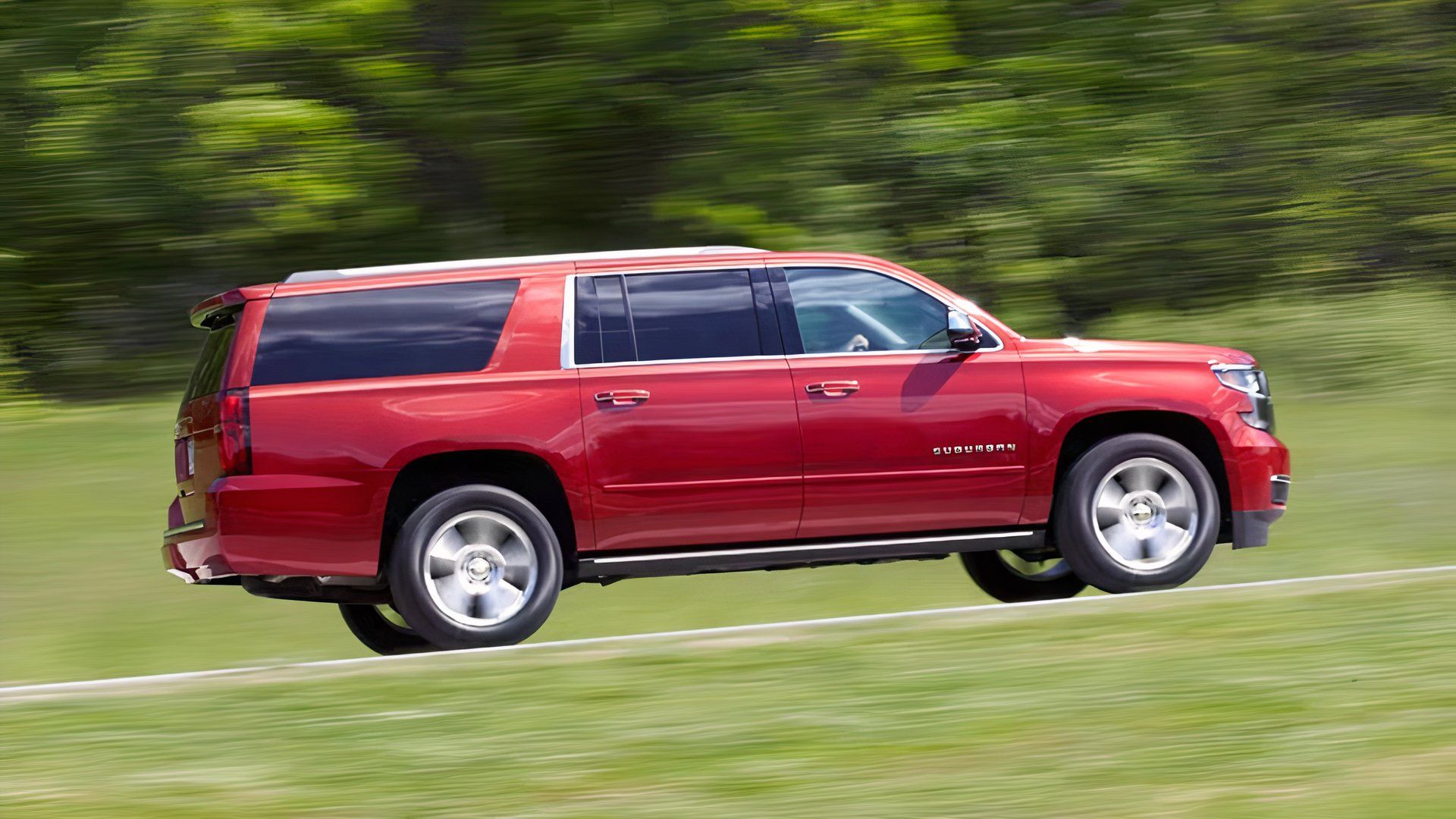 2020 Chevrolet Suburban in red being driven