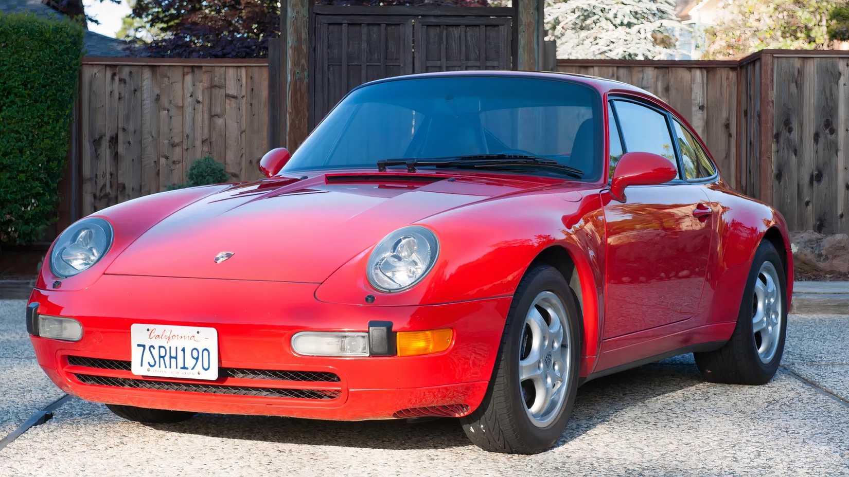 1995 Porsche 911 Carrera 2 in red parked