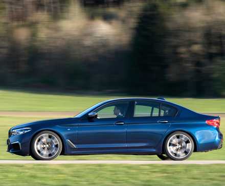 BMW M550i in blue being driven